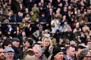 11 March 2025; Members of the crowd applaud as a photograph of the late Jockey Michael O'Sullivan is shown on the big screen to racing on day one of the Cheltenham Racing Festival at Prestbury Park in Cheltenham, England. Photo by David Fitzgerald/Sportsfile