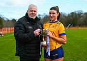 13 March 2025; DCU Dóchas Éireann captain Aoibheann O'Connor is presented with the trophy by Ladies HEC Chairperson, Daniel Caldwell, following her side's victory in the 2025 AIG HEC Cup Final between UU Coleraine and DCU Dóchas Éireann at Queen’s Sport, Belfast. Photo by Shauna Clinton/Sportsfile