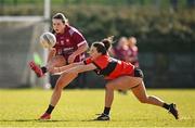 14 March 2025; Aoife Stauntion of UG is tackled by Roisin Ennis of UCC during the 2025 Ladies AIG HEC O'Connor Cup semi-final match between University College Cork and University of Galway at Queen's Sport, Queens University, Belfast. Photo by Shauna Clinton/Sportsfile