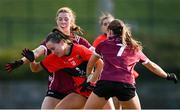 14 March 2025; Emily Lacy of UCC in action against UG players Marta Barek, left, and Joanne Reilly during the 2025 Ladies AIG HEC O'Connor Cup semi-final match between University College Cork and University of Galway at Queen's Sport, Queens University, Belfast. Photo by Shauna Clinton/Sportsfile