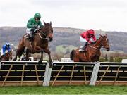 14 March 2025; Jasmin De Vaux, with Paul Townend up, left, jump the last on their way to winning The Albert Bartlett  Novices’ Hurdle Race, ahead of The Big Westerner, with Darragh O'Keeffe up, who finished second, on day four of the Cheltenham Racing Festival at Prestbury Park in Cheltenham, England. Photo by Harry Murphy/Sportsfile