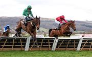 14 March 2025; Jasmin De Vaux, with Paul Townend up, left, jump the last on their way to winning The Albert Bartlett  Novices’ Hurdle Race, ahead of The Big Westerner, with Darragh O'Keeffe up, who finished second, on day four of the Cheltenham Racing Festival at Prestbury Park in Cheltenham, England. Photo by Harry Murphy/Sportsfile