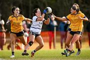 14 March 2025; Maria O'Neill of UU Belfast is tackled by DCU DÉ players Laoise Lenehan, left, and Sarah Reynolds during the 2025 Ladies AIG HEC O'Connor Cup semi-final match between DCU Dóchas Éireann and UU Belfast at Queen's Sport, Queens University, Belfast. Photo by Shauna Clinton/Sportsfile