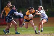 14 March 2025; Leah Fox of DCU DÉ is tackled by UU Belfast players Cara Bradley, left, and Maeve Ferguson during the 2025 Ladies AIG HEC O'Connor Cup semi-final match between DCU Dóchas Éireann and UU Belfast at Queen's Sport, Queens University, Belfast. Photo by Shauna Clinton/Sportsfile