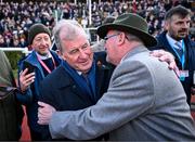 14 March 2025; JP McManus, owner of the winning horse Inothewayurthinkin, is congratulated by Greg Turley, owner of second placed Galopin Des Champs, after Boodles Cheltenham Gold Cup Steeple Chase on day four of the Cheltenham Racing Festival at Prestbury Park in Cheltenham, England. Photo by David Fitzgerald/Sportsfile