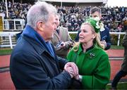 14 March 2025; JP McManus, owner of the winning horse Inothewayurthinkin, is congratulated by Audrey Turley, owner of second placed Galopin Des Champs, after Boodles Cheltenham Gold Cup Steeple Chase on day four of the Cheltenham Racing Festival at Prestbury Park in Cheltenham, England. Photo by David Fitzgerald/Sportsfile