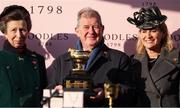 14 March 2025; Princess Anne, Princess Royal, with winning owner JP McManus, daughter Sue Anne, and the Boodles Cheltenham Gold Cup after Inothewayurthinkin won the Boodles Cheltenham Gold Cup Steeple Chase on day four of the Cheltenham Racing Festival at Prestbury Park in Cheltenham, England. Photo by Harry Murphy/Sportsfile