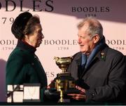 14 March 2025; Princess Anne, Princess Royal, with winning owner JP McManus and the Boodles Cheltenham Gold Cup after Inothewayurthinkin won the Boodles Cheltenham Gold Cup Steeple Chase on day four of the Cheltenham Racing Festival at Prestbury Park in Cheltenham, England. Photo by Harry Murphy/Sportsfile