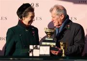 14 March 2025; Princess Anne, Princess Royal, with winning owner JP McManus and the Boodles Cheltenham Gold Cup after Inothewayurthinkin won the Boodles Cheltenham Gold Cup Steeple Chase on day four of the Cheltenham Racing Festival at Prestbury Park in Cheltenham, England. Photo by Harry Murphy/Sportsfile