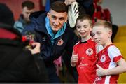 14 March 2025; Mason Melia of St Patrick's Athletic poses for a photograph with supporters before the SSE Airtricity Men's Premier Division match between St Patrick's Athletic and Bohemians at Richmond Park in Dublin. Photo by Stephen McCarthy/Sportsfile