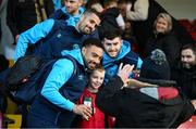 14 March 2025; St Patrick's Athletic players, from left, Jake Mulraney, Zach Elbouzedi and Aidan Keena pose for a photograph with supporters on arrival for the SSE Airtricity Men's Premier Division match between St Patrick's Athletic and Bohemians at Richmond Park in Dublin. Photo by Stephen McCarthy/Sportsfile