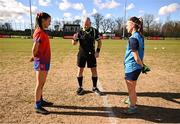 15 March 2025; Referee Shane Curley performs the coin-toss in the company of team captains Aoife Dillane of MIC Limerick, left, and Saoirse Lally of UCD before the 2025 Ladies AIG Giles Cup final match between MIC Limerick and UCD at Queen's Sport, Queens University, Belfast. Photo by Ben McShane/Sportsfile