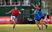 15 March 2025; Rachel Dwyer of MIC Limerick kicks a point despite the attention of Katie McCaffrey, centre, and Saoirse Lally of UCD during the 2025 Ladies AIG Giles Cup final match between MIC Limerick and UCD at Queen's Sport, Queens University, Belfast. Photo by Ben McShane/Sportsfile