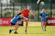 15 March 2025; Ella Thompson of MIC Limerick kicks a point despite the tackle of Ciara Crowley of UCD during the 2025 Ladies AIG Giles Cup final match between MIC Limerick and UCD at Queen's Sport, Queens University, Belfast. Photo by Ben McShane/Sportsfile