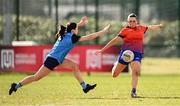 15 March 2025; Ella Thompson of MIC Limerick kicks a point despite the tackle of Ciara Crowley of UCD during the 2025 Ladies AIG Giles Cup final match between MIC Limerick and UCD at Queen's Sport, Queens University, Belfast. Photo by Ben McShane/Sportsfile