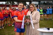 15 March 2025; MIC Limerick captain Aoife Dillane is presented Giles Cup from Ladies Gaelic Football Association President, Trina Murray, after the 2025 Ladies AIG Giles Cup final match between MIC Limerick and UCD at Queen's Sport, Queens University, Belfast. Photo by Ben McShane/Sportsfile