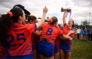15 March 2025; MIC Limerick captain Aoife Dillane celebrates with the Giles Cup and her teammates after the 2025 Ladies AIG Giles Cup final match between MIC Limerick and UCD at Queen's Sport, Queens University, Belfast. Photo by Ben McShane/Sportsfile