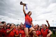 15 March 2025; MIC Limerick captain Aoife Dillane celebrates with the Giles Cup and her teammates after the 2025 Ladies AIG Giles Cup final match between MIC Limerick and UCD at Queen's Sport, Queens University, Belfast. Photo by Ben McShane/Sportsfile