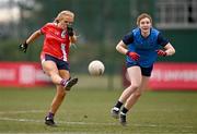 15 March 2025; Maeve Daly of MTU Cork kicks a point despite the attention of Roisin McKenna of UCD 2 during the 2025 Ladies AIG Lynch final match between MTU Cork and UCD at Queen's Sport, Queens University, Belfast. Photo by Ben McShane/Sportsfile