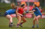 15 March 2025; Ava Looney of MTU Cork is tackled by Roisin McKenna, left, and Hannah Crowley of UCD 2 during the 2025 Ladies AIG Lynch final match between MTU Cork and UCD at Queen's Sport, Queens University, Belfast. Photo by Ben McShane/Sportsfile