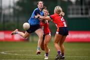 15 March 2025; Ava Briscoe of UCD 2 is tackled by Ellen Moore, centre, and Siobhan Callanan of MTU Cork during the 2025 Ladies AIG Lynch final match between MTU Cork and UCD at Queen's Sport, Queens University, Belfast. Photo by Ben McShane/Sportsfile