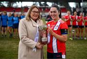 15 March 2025; MTU Cork captain Rachael Evans is presented with the Cup by Ladies Gaelic Football Association President Trina Murray after the 2025 Ladies AIG Lynch final match between MTU Cork and UCD at Queen's Sport, Queens University, Belfast. Photo by Ben McShane/Sportsfile