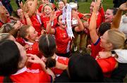 15 March 2025; MTU Cork captain Rachael Evans celebrates with her teammates and the Lynch Cup after the 2025 Ladies AIG Lynch final match between MTU Cork and UCD at Queen's Sport, Queens University, Belfast. Photo by Ben McShane/Sportsfile