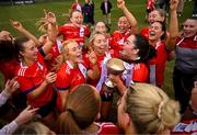 15 March 2025; MTU Cork captain Rachael Evans celebrates with her teammates and the Lynch Cup after the 2025 Ladies AIG Lynch final match between MTU Cork and UCD at Queen's Sport, Queens University, Belfast. Photo by Ben McShane/Sportsfile