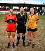 15 March 2025; Referee Eddie Cuthbert with team captains Rachel Sheehan of UCC, left, and Emma Duggan of DCU Dóchas Éireann before the 2025 Ladies AIG O’Connor Cup final match between DCU Dóchas Éireann and UCC at Queen's Sport, Queens University, Belfast. Photo by Ben McShane/Sportsfile