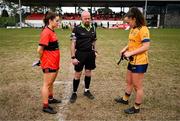 15 March 2025; Referee Eddie Cuthbert performs the coin-toss with team captains Rachel Sheehan of UCC, left, and Emma Duggan of DCU Dóchas Éireann before the 2025 Ladies AIG O’Connor Cup final match between DCU Dóchas Éireann and UCC at Queen's Sport, Queens University, Belfast. Photo by Ben McShane/Sportsfile