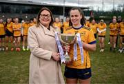 15 March 2025; DCU Dóchas Éireann captain Emma Duggan is presented with the AIG O'Connor Cup by Ladies Gaelic Football Association President Trina Murray after the 2025 Ladies AIG O’Connor Cup final match between DCU Dóchas Éireann and UCC at Queen's Sport, Queens University, Belfast. Photo by Ben McShane/Sportsfile