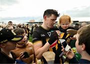 15 March 2025; TJ Reid of Kilkenny, accompanied by his daughter Harper Reid, aged 2,  signs autographs for supporters after the Allianz Hurling League Division 1A match between Kilkenny and Limerick at UPMC Nowlan Park in Kilkenny. Photo by Sam Barnes/Sportsfile