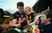15 March 2025; TJ Reid of Kilkenny, accompanied by his daughter Harper Reid, aged 2,  signs autographs for supporters after the Allianz Hurling League Division 1A match between Kilkenny and Limerick at UPMC Nowlan Park in Kilkenny. Photo by Sam Barnes/Sportsfile