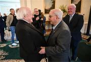 15 March 2025; President of Ireland Michael D Higgins with kitman Charlie O’Leary of the Republic of Ireland squad from the Italia 1990 FIFA World Cup at Áras an Uachtaráin in Dublin. Photo by Stephen McCarthy/Sportsfile