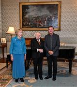 15 March 2025; President of Ireland Michael D Higgins and wife Sabina with Kevin Moran of the Republic of Ireland squad from the Italia 1990 FIFA World Cup at Áras an Uachtaráin in Dublin. Photo by Stephen McCarthy/Sportsfile