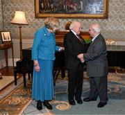 15 March 2025; President of Ireland Michael D Higgins and wife Sabina with kitman Charlie O’Leary of the Republic of Ireland squad from the Italia 1990 FIFA World Cup at Áras an Uachtaráin in Dublin. Photo by Stephen McCarthy/Sportsfile