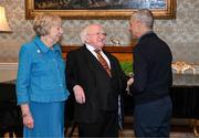 15 March 2025; President of Ireland Michael D Higgins and wife Sabina with Chris Hughton of the Republic of Ireland squad from the Italia 1990 FIFA World Cup at Áras an Uachtaráin in Dublin. Photo by Stephen McCarthy/Sportsfile