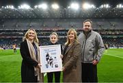 15 March 2025: Ava Connellan of St Pius X NS Terenure receives a presentation as best player for the Allianz Cumann na mBunscol Finals by Allianz sponsorship executive Katie Bradley, left, LGFA chief executive officer Helen O'Rourke, and Mike Smyth from Cumann na mBunscol at half-time in Saturday’s Allianz Football League Division 1 match between Dublin and Galway at Croke Park. Photo by Piaras Ó Mídheach/Sportsfile