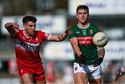 16 March 2025; Jordan Flynn of Mayo in action against Conor Doherty of Derry during the Allianz Football League Division 1 match between Derry and Mayo at Celtic Park in Derry. Photo by Ben McShane/Sportsfile