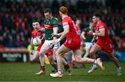 16 March 2025; Matthew Ruane of Mayo in action against Derry players, from left, Niall Toner, Conor Glass and Conor Doherty during the Allianz Football League Division 1 match between Derry and Mayo at Celtic Park in Derry. Photo by Ben McShane/Sportsfile