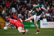 16 March 2025; Frank Irwin of Mayo has a shot on goal blocked by Padraig McGrogan of Derry during the Allianz Football League Division 1 match between Derry and Mayo at Celtic Park in Derry. Photo by Ben McShane/Sportsfile