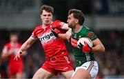 16 March 2025; Aidan O'Shea of Mayo pushes off the tackle of Eoin McEvoy of Derry during the Allianz Football League Division 1 match between Derry and Mayo at Celtic Park in Derry. Photo by Ben McShane/Sportsfile