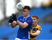 16 March 2025; Óisin Kiernan of Cavan is tackled by Colm Neary of Roscommon during the Allianz Football League Division 2 match between Roscommon and Cavan at King & Moffatt Dr Hyde Park in Roscommon. Photo by Tom Beary/Sportsfile
