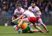 16 March 2025; Mark Curran of Donegal in action against Tyrone players, from left, Mark Bradley, Kieran McGeary and Peter Teague during the Allianz Football League Division 1 match between Donegal and Tyrone at O’Donnell Park in Letterkenny, Donegal. Photo by Piaras Ó Mídheach/Sportsfile