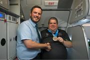16 March 2025; Bronze Medal winner James Upton of Team Ireland, a member of Waterford Special Olympics Club, Passage East, Waterford, with Liam O'Shea, Senior Cabin Crew, on the flight to Dublin airport after competing in the Turin 2025 Special Olympics World Winter Games in Italy. Photo by Ray McManus/Sportsfile