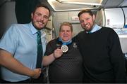 16 March 2025; Bronze Medal winner James Upton of Team Ireland, a member of Waterford Special Olympics Club, Passage East, Waterford, with Liam O'Shea, left, Senior Cabin Crew, and William McNally, Cabin Crew, on the flight to Dublin airport after competing in the Turin 2025 Special Olympics World Winter Games in Italy. Photo by Ray McManus/Sportsfile
