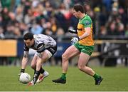 16 March 2025; Tyrone goalkeeper Niall Morgan in action against Jamie Brennan of Donegal during the Allianz Football League Division 1 match between Donegal and Tyrone at O’Donnell Park in Letterkenny, Donegal. Photo by Piaras Ó Mídheach/Sportsfile