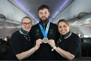 16 March 2025; Bronze Medal winner Gavin Bourke of Team Ireland, a member of Mallow Special Olympics Club, Doneraile, Cork, with Sinéad Curran, left, Line Standards Supervisor, and Geri Cunningham, Cabin Crew, on the Aer Lingus flight to Dublin after competing in the Turin 2025 Special Olympics World Winter Games in Italy. Photo by Ray McManus/Sportsfile