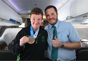 16 March 2025; Bronze Medal winner Frank O'Dwyer of Team Ireland, a member of Tipperary Special Olympics Club, Ballylandis, Limerick, with Liam O'Shea, Senior Cabin Crew, on the Aer Lingus flight to Dublin after competing in the Turin 2025 Special Olympics World Winter Games in Italy. Photo by Ray McManus/Sportsfile