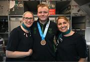 16 March 2025; Bronze Medal winner Joseph 'Joe-Joe' Sheehan of Team Ireland, a member of Mallow Special Olympics Club, Doneraile, Cork, with Sinéad Curran, left, Line Standards Supervisor, and Geri Cunningham, Cabin Crew, on the Aer Lingus flight to Dublin after competing in the Turin 2025 Special Olympics World Winter Games in Italy. Photo by Ray McManus/Sportsfile
